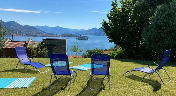Sun loungers on the lawn above the pool, looking over Lake Maggiore