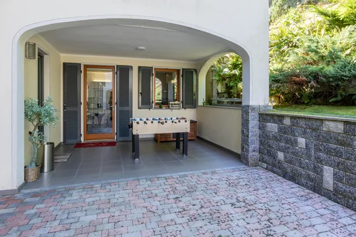 Arched portico with table football and doors leading back into the villa