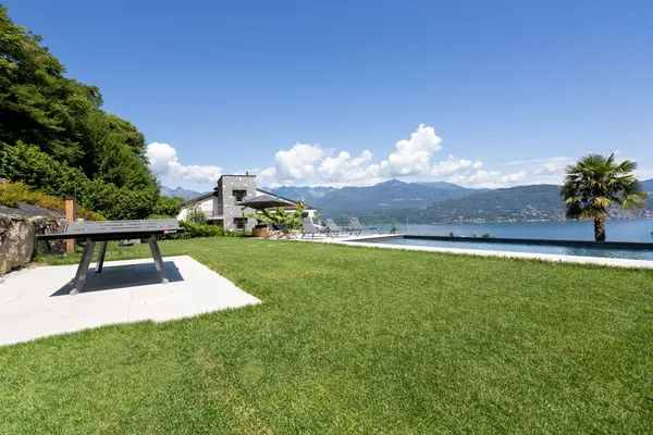 The lawn and bench beside the private pool, looking down to the lake