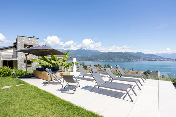 The solarium beside the private pool, with loungers facing Lake Maggiore